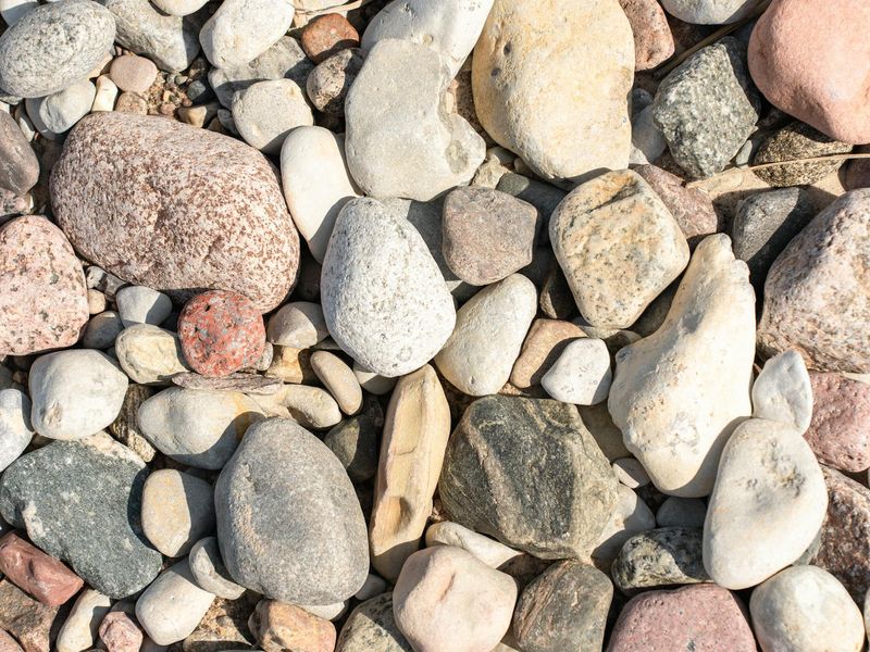 Minimalist arrangement of smooth stones and ice structures